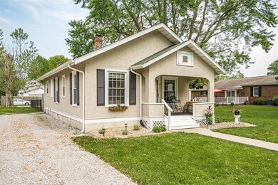 Welcoming front porch with room for chairs and a s