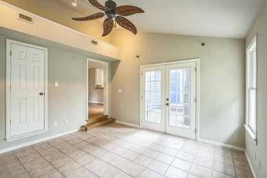 Unfurnished room featuring french doors, vaulted 
