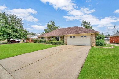 Ranch-style home with a front lawn and a garage