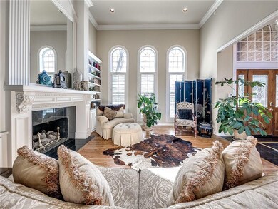 The gas fireplace is surrounded by rich marble and