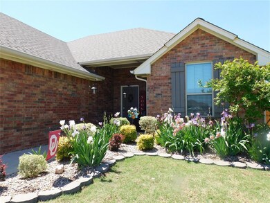 Property entrance featuring a lawn, brick siding, 