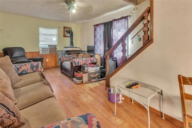 Bedroom with ceiling fan and hardwood / wood-style