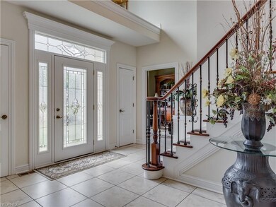 Two story ceramic foyer with sweeping curved stair
