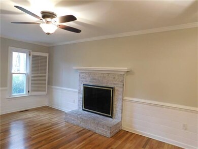 Family room with brick fireplace and ceiling fan