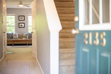 Corridor with baseboards, carpet, and stairs