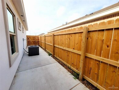 Fenced backyard featuring cooling unit and a patio area