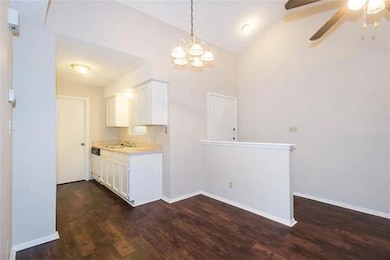 Kitchen featuring light countertops, ceiling fan,