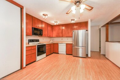Kitchen with brown cabinets, light countertops, wh
