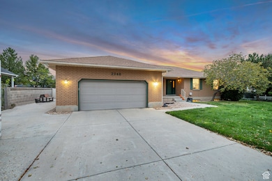 Ranch-style home with brick siding, concrete driveway, an attached garage, and roof with shingles