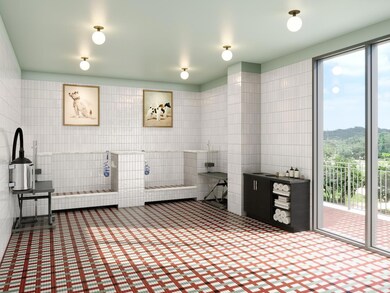 Pet spa with indoor wash and grooming stations, towel storage, and direct access to the outdoor pet area. Designed as a comfortable, social space where residents can enjoy time with their pets and friends.