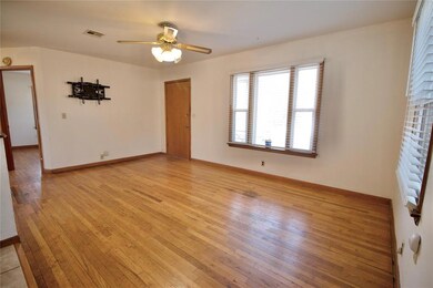 Empty room featuring ceiling fan and light hardwoo