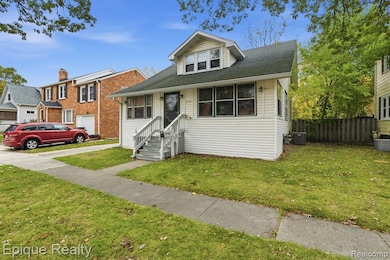 Bungalow-style home with roof with shingles and a front lawn