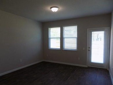 Unfurnished room featuring dark wood finished flo