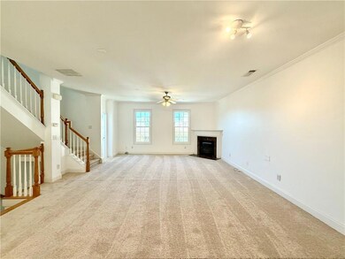The Family Room with a cozy gas fireplace and entry stairs from front door as well as stairs leading up to the bedrooms. Notice the new windows bringing natural light into the home.