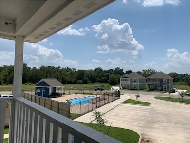 Balcony featuring view of pool