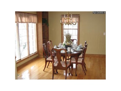 The spacious Dining Room with hardwood floor is fl
