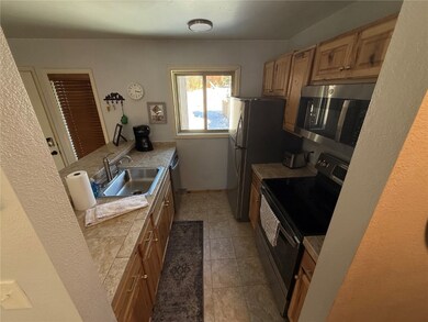 Kitchen with sink, light tile patterned floors, an