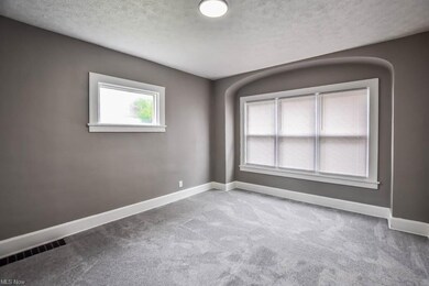 Carpeted dining room with a textured ceiling