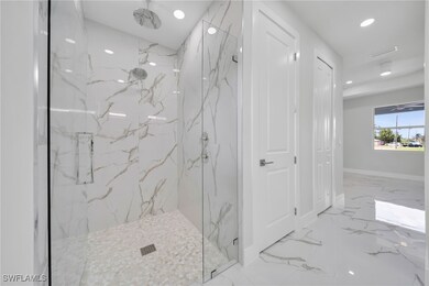 Bathroom with marble tiled floors, a marble finish