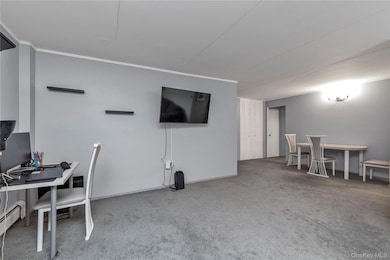 Office area with light colored carpet and baseboards