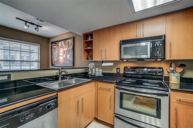 The roomy kitchen features black granite, brushed 
