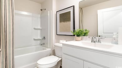 Full bathroom with vanity, shower / bath combo wit