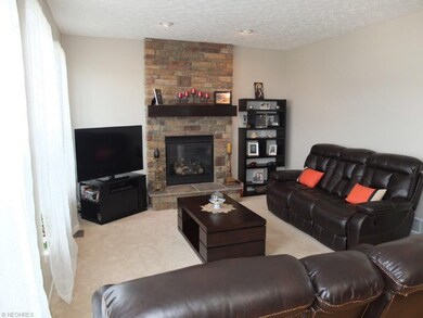 Great room has a stone fireplace.