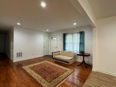 Living room with dark hardwood / wood-style floori