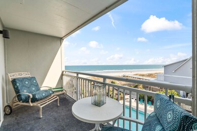 Balcony featuring a water view and a beach view