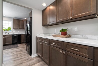 Butler's pantry located between the kitchen and li