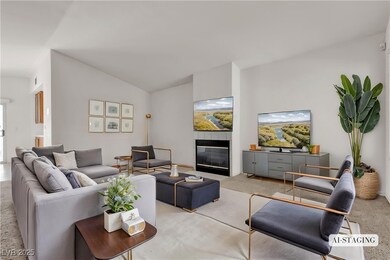 Living area with light carpet, a tiled fireplace,