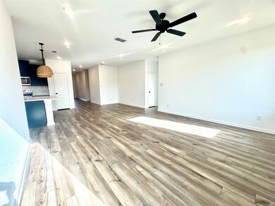 Unfurnished living room featuring a ceiling fan, l