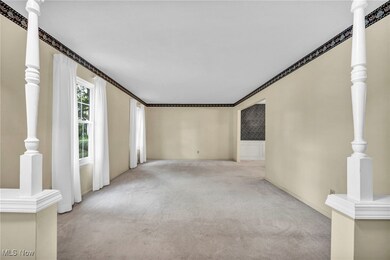 Carpeted spare room with ornamental molding
