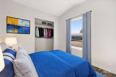 Bedroom featuring wood finished floors, a closet, and vaulted ceiling