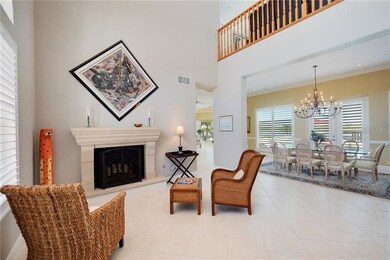 Two-story foyer with gas fireplace.