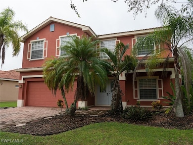 View of front facade featuring stucco siding, driveway, and an attached garage