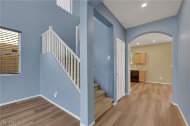 Staircase featuring arched walkways, recessed ligh