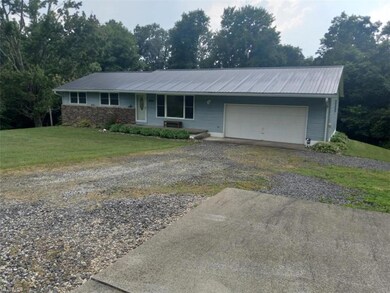 Front of home with garage and deck.