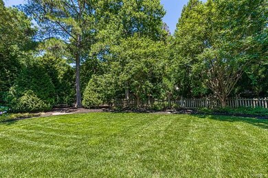 The fenced rear yard is beautifully landscaped and