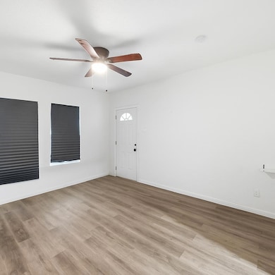 Foyer entrance with light wood-style floors and ceiling fan