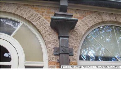 Ornamental cast concrete panels,arched windows and