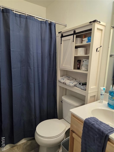 Bathroom featuring vanity and curtained shower