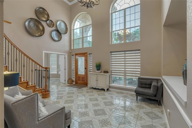 Entrance foyer featuring baseboards, a towering ce