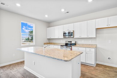 Kitchen with stainless steel appliances, an island