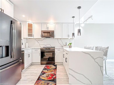Kitchen with glass insert cabinets, white cabinets