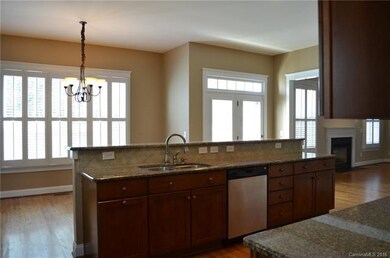 Island Style Kitchen with Granite and Tile Backspl