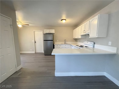 Kitchen featuring freestanding refrigerator, white