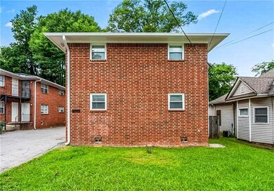 View of property exterior with crawl space, brick siding, and a lawn