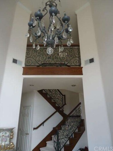 Cathedral ceiling Entry with chandelier and Wrough