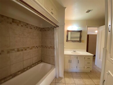Bathroom with vanity, tile patterned floors, and shower / tub combo with curtain